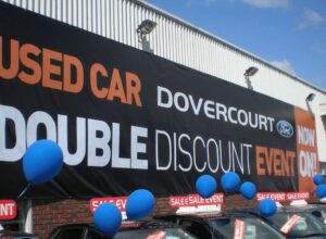 a large pvc printed banner showing details of a car sales event