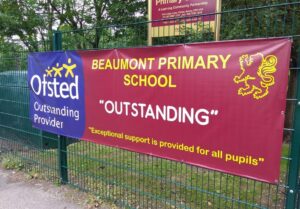 a high quality printed banner mounted on railings detailing a schools ofsted results